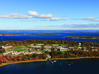 An aerial image of the Roger Williams campus and Mount Hope Bay